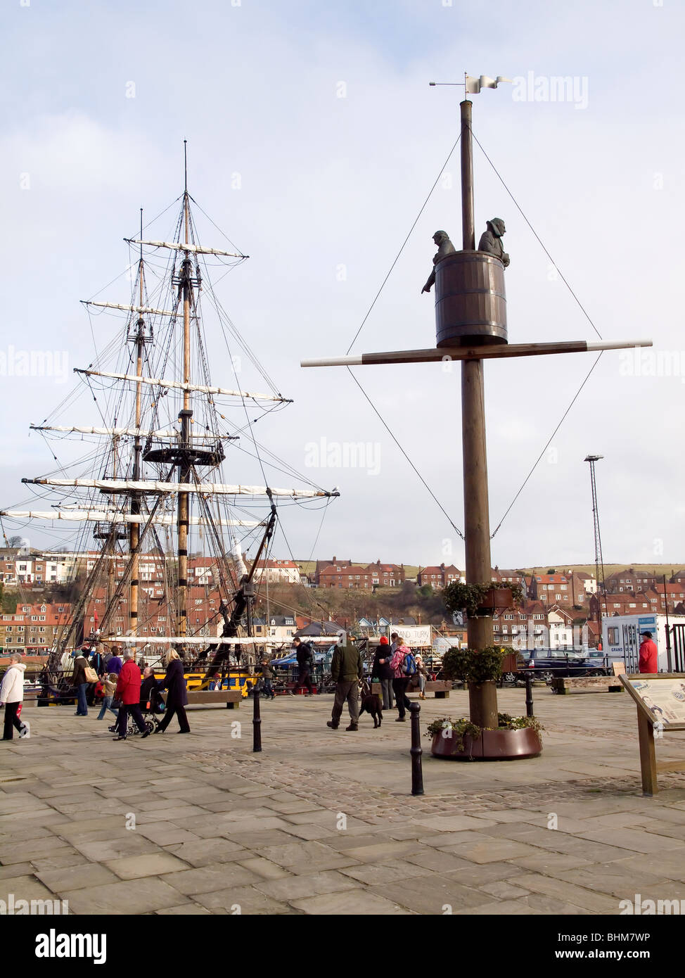 Statue in Whitby of the 'barrel' Crow's Nest invented by local mariner William Scoresby and the replica  sailing ship Grand Turk Stock Photo