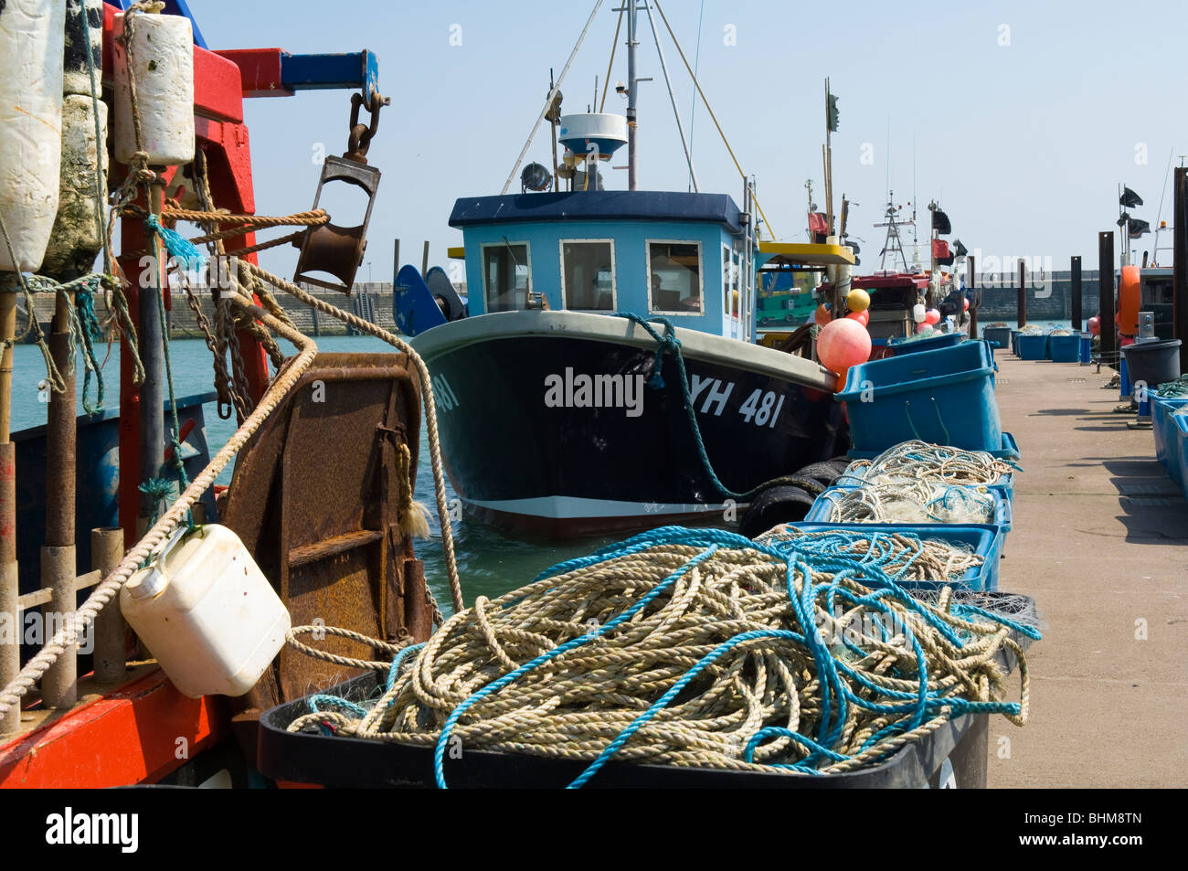 Fishing boats in the Royal Harbour at Ramsgate, Kent, United Kingdom. The large crates are used