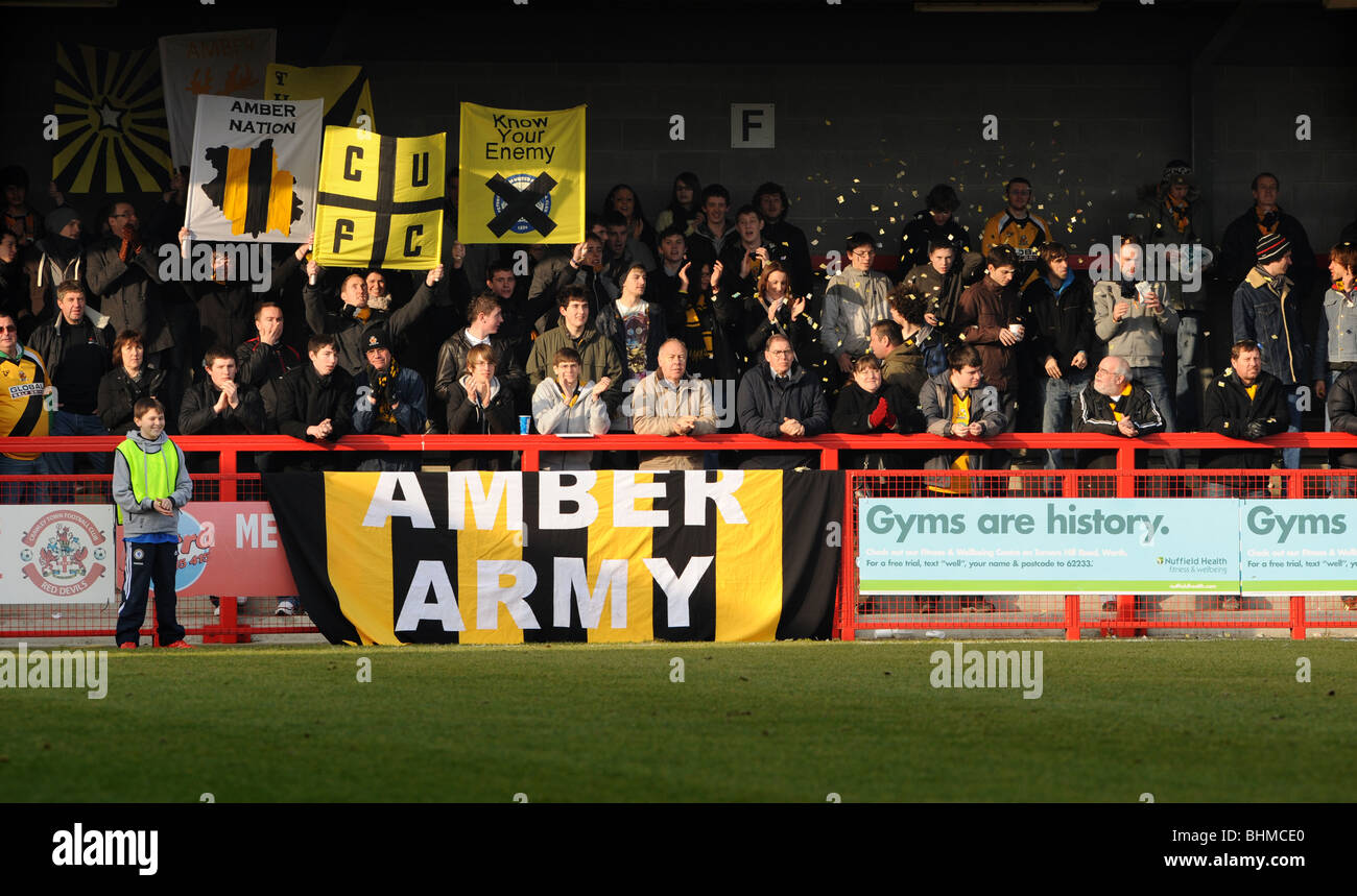 Cambridge united football fans cheer as their team comes on Stock Photo