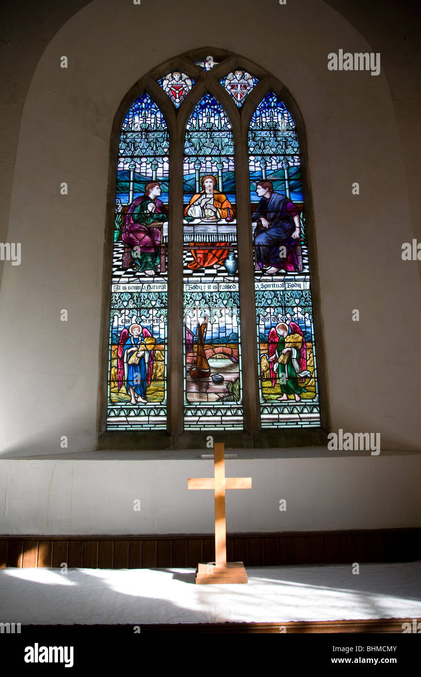 Stained glass window and altar crucifix, St John the Baptist church
