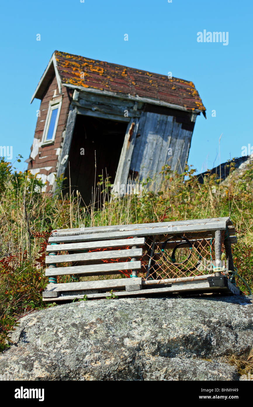 An old outhouse and lobster trap at Peggy's Peggys Cove, Nova Scotia, Canada Stock Photo