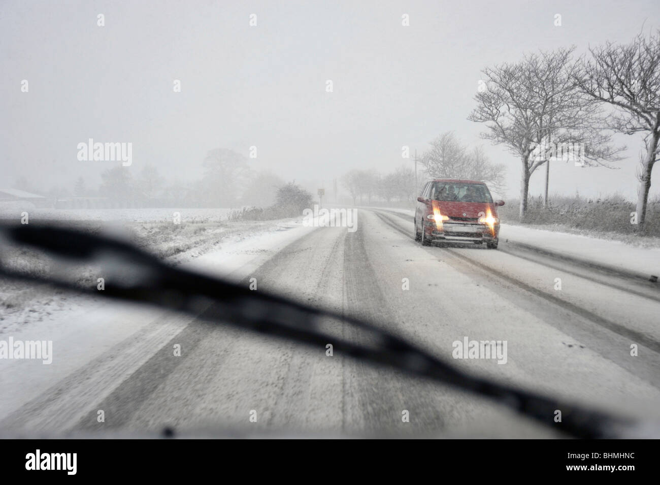Driving on a winter snow covered road Stock Photo - Alamy