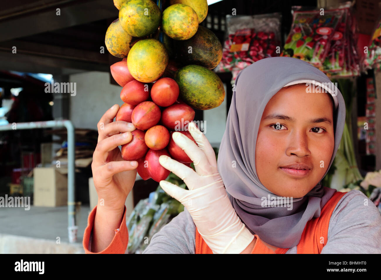 Young Malay woman selling fruit in front of her food store in Cameron Highlands Malaysia Stock Photo