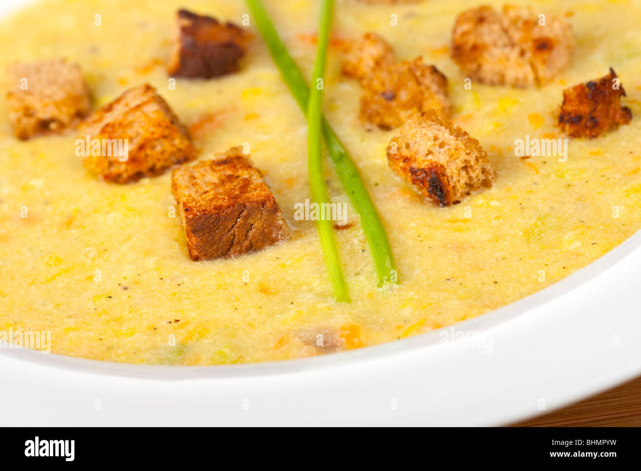 potato soup with croutons and chive strands Stock Photo