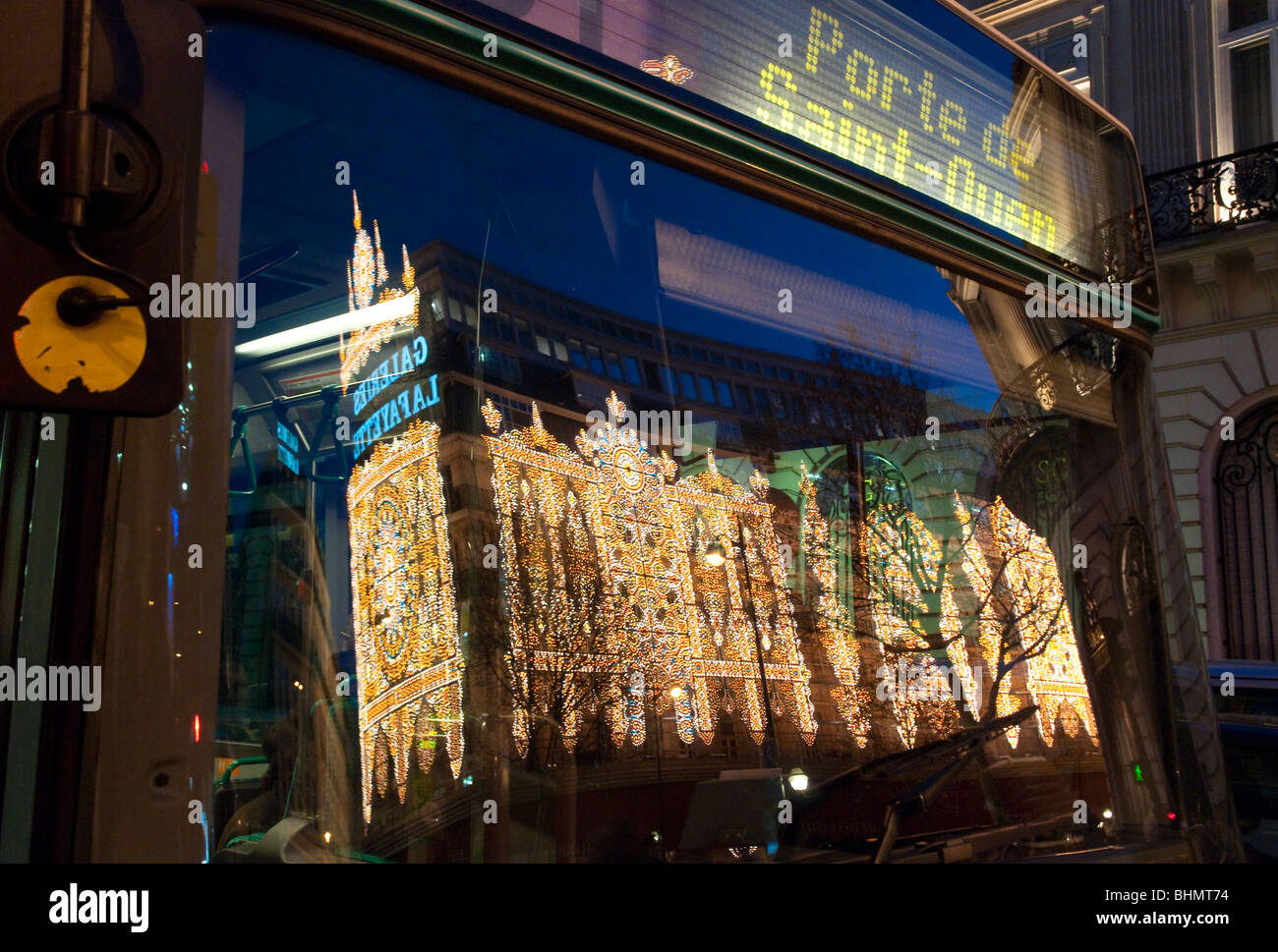 reflection in bus windscreen of christmas lights at Galerie Lafayette in Paris Stock Photo