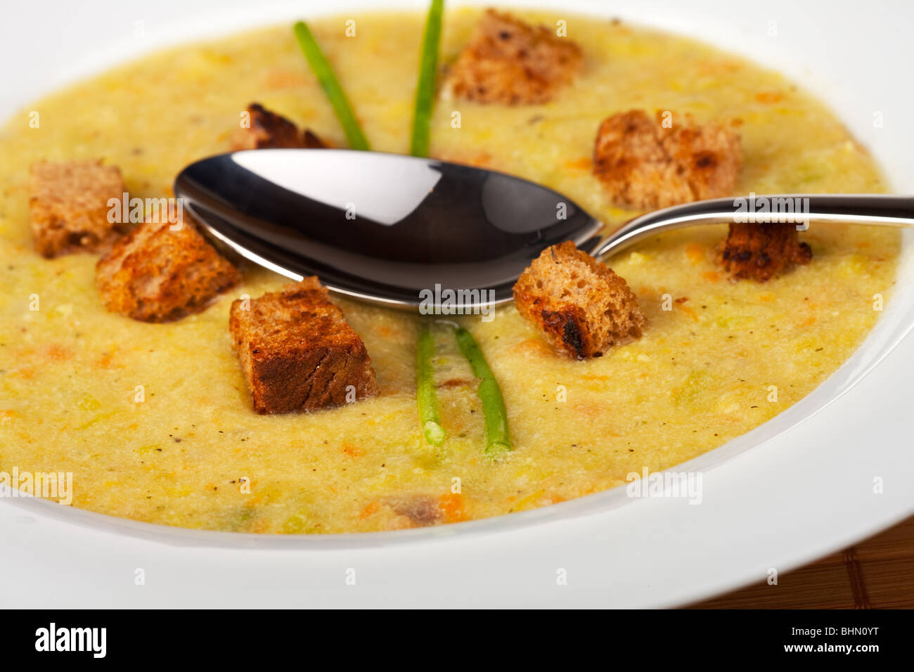 potato soup with croutons and chive strands Stock Photo