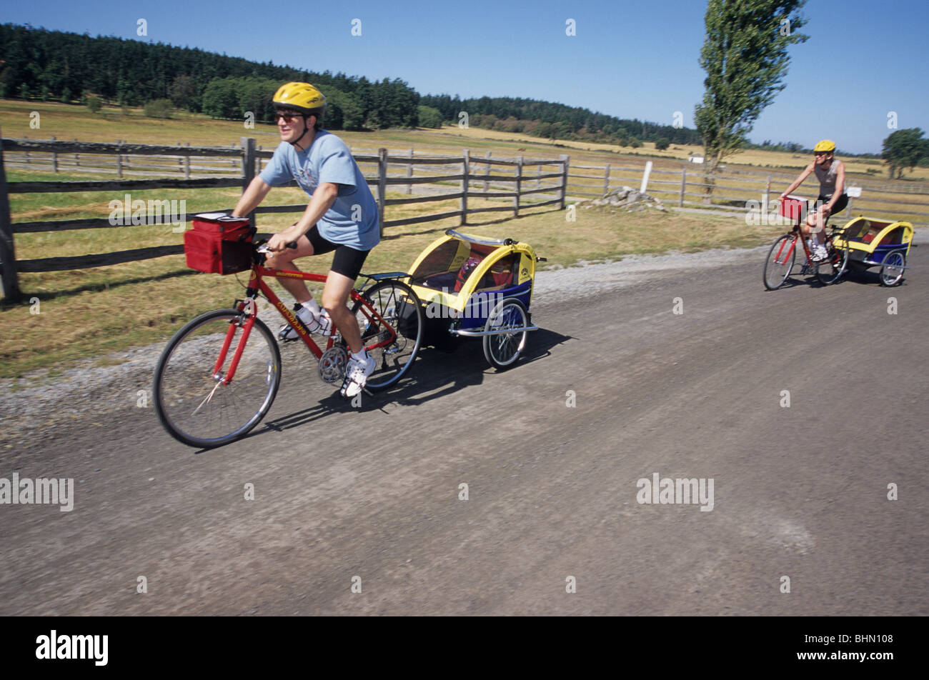 Family riding bikes with children. Stock Photo