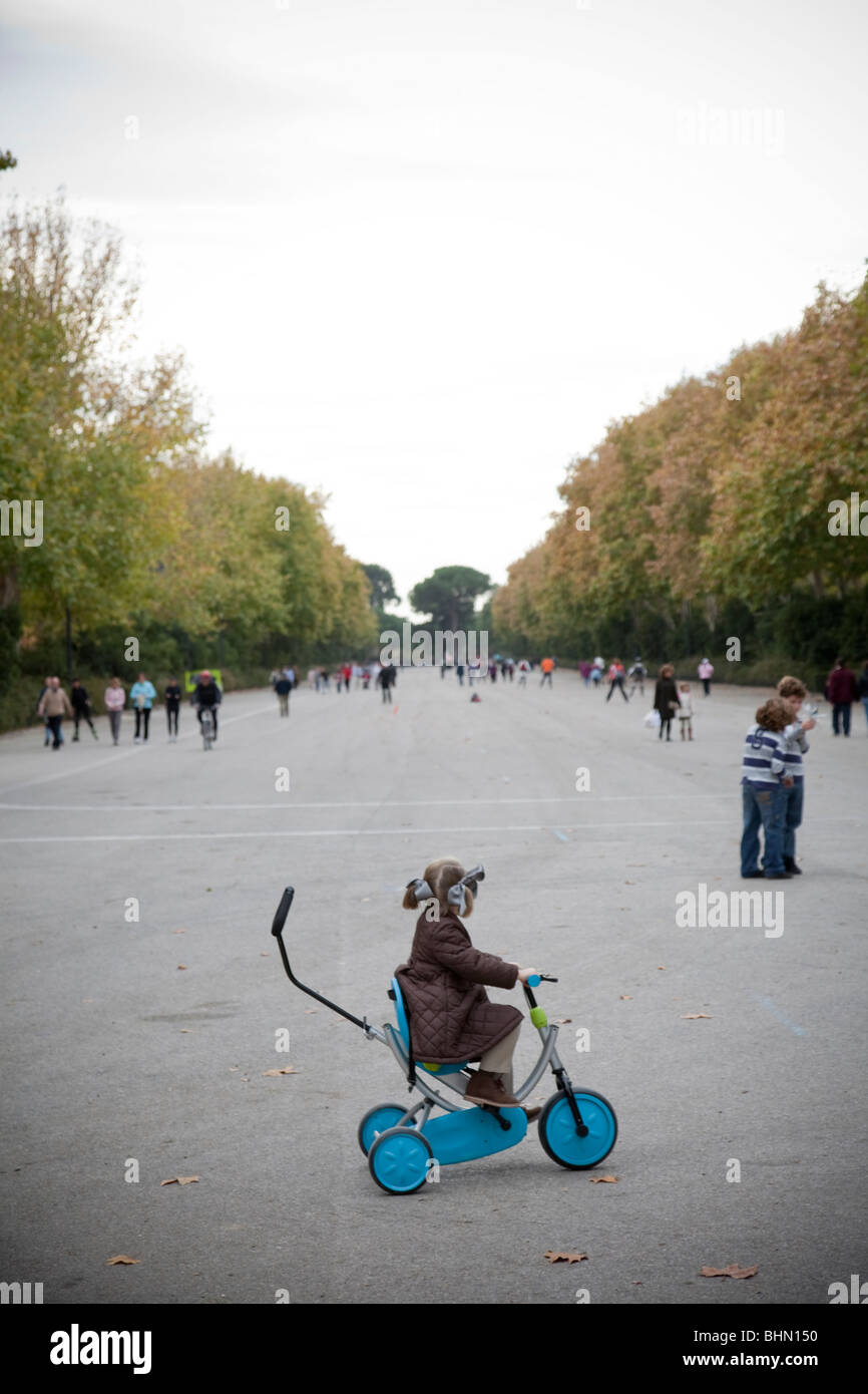 Girl riding a tricycle at the Retiro Park in Madrid Stock Photo Alamy