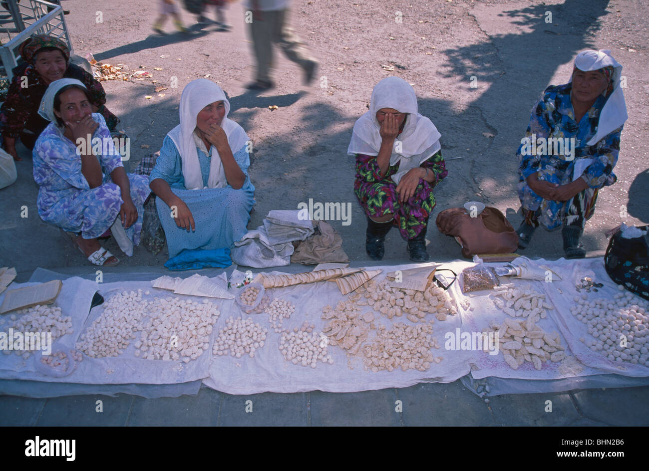 Uzbek woman selling cheese at the market, Ferghana, Uzbekistan Stock Photo