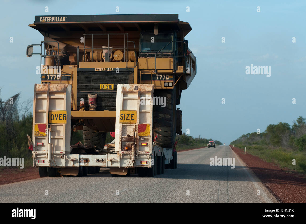 Heavy mining equipment being delivered to mine site on outback highway near Karratha, Western Australia Stock Photo