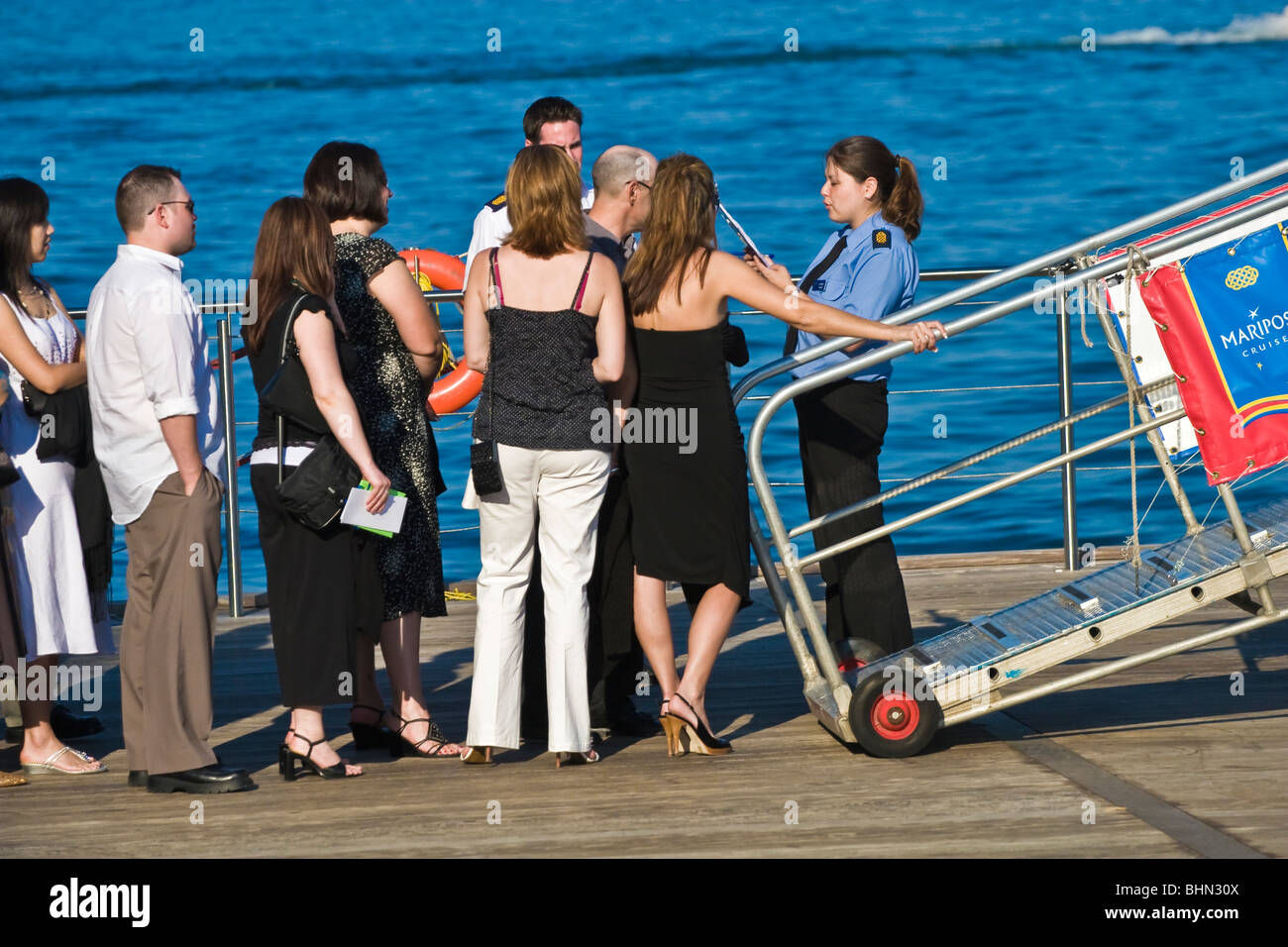 Female security officer admitting passengers onto a cruise boat, Lake Ontario, Toronto harborfront Stock Photo