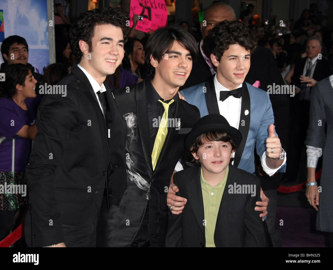 The Jonas Brothers, Nick Jonas, Joe Jonas and Kevin Jonas and little brother  Frankie Jonas The New York Premiere of the Disney Stock Photo - Alamy