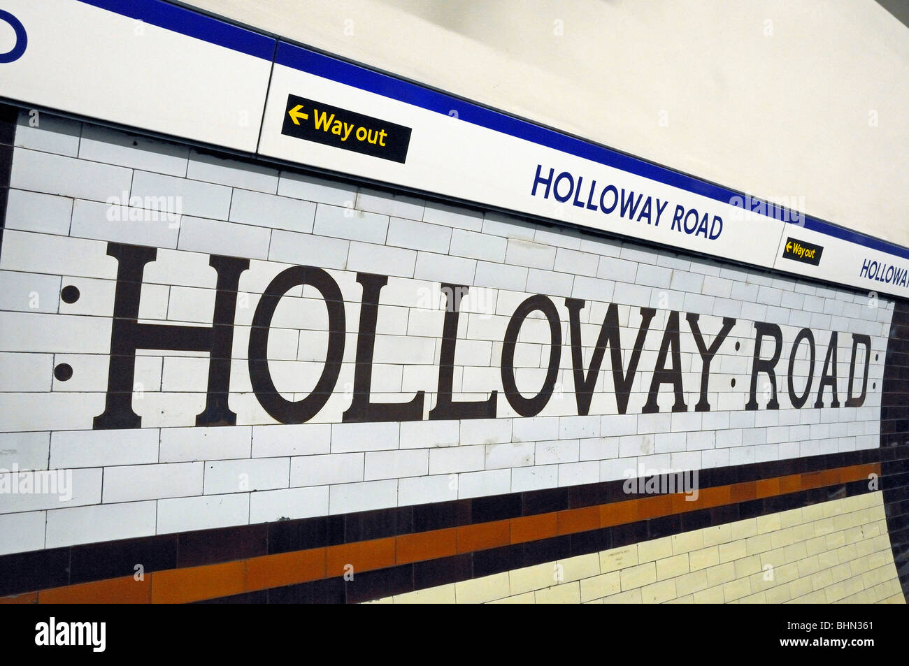 Old glazed bricks spelling out Holloway Road an Underground Station on the Piccadilly Line London England UK Stock Photo