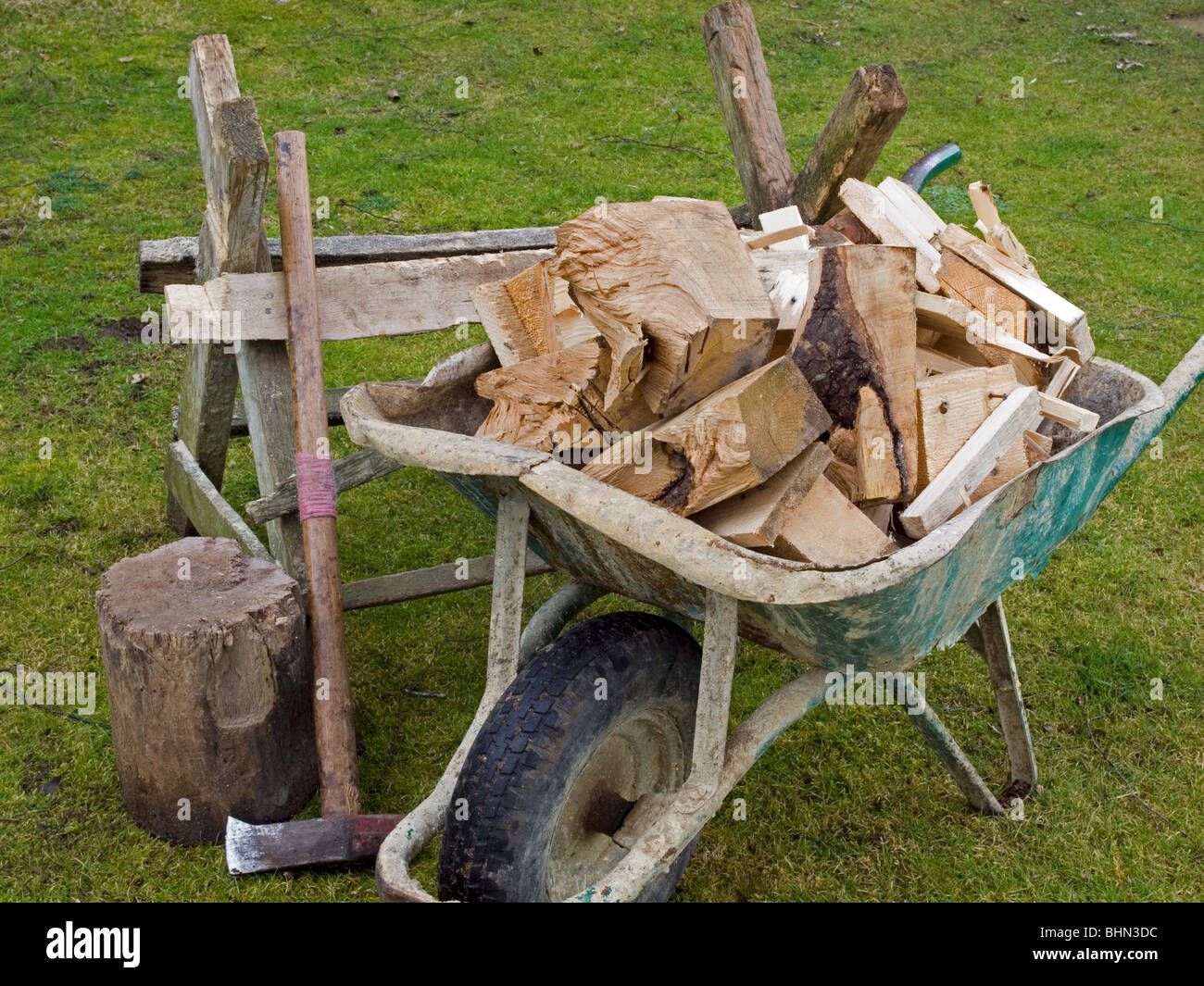 saw bench wood cutting tools wheelbarrow firewood Stock Photo - Alamy