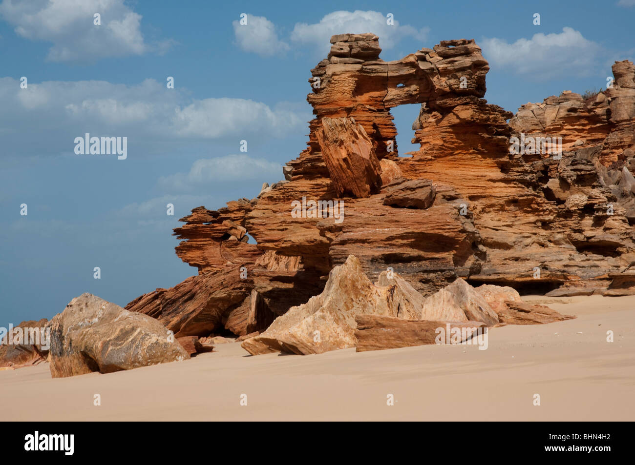 Ruigged red cliff and sandstone rock formations at Echo Beach on the West Australian coast near Broome Stock Photo