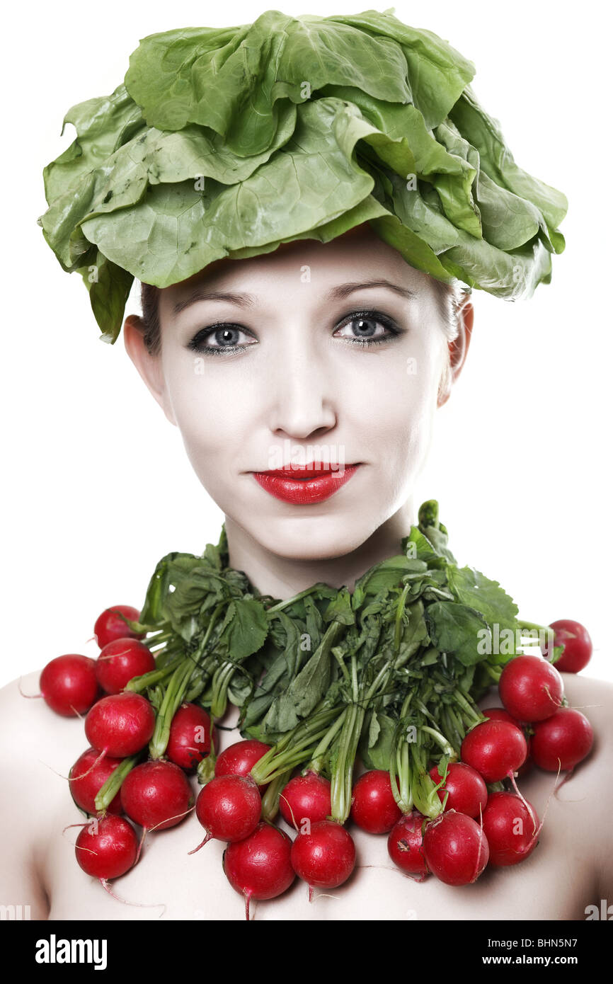 Young woman with a lettuce on her head and radishes round her neck