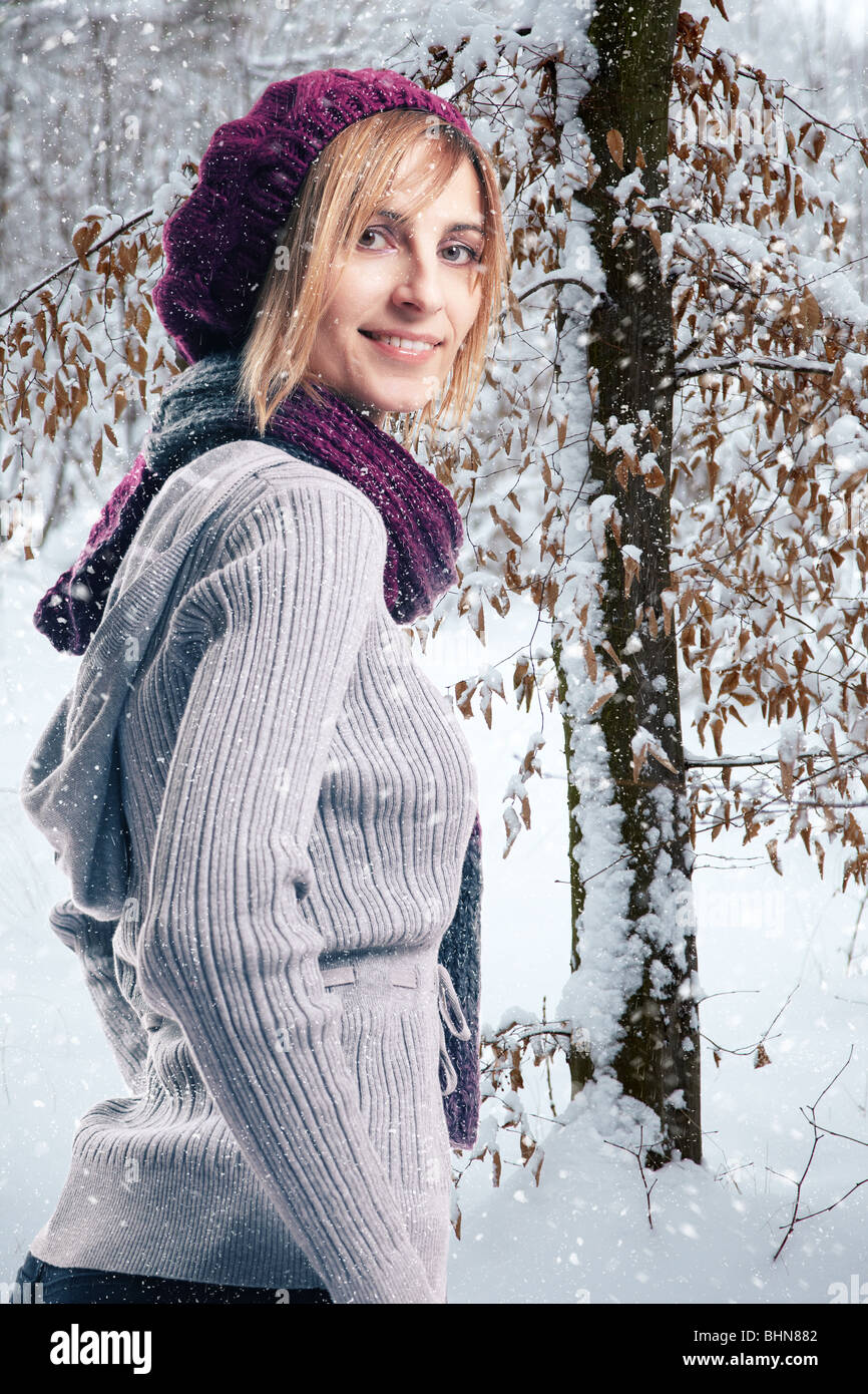 Woman in snow-covered forest Stock Photo