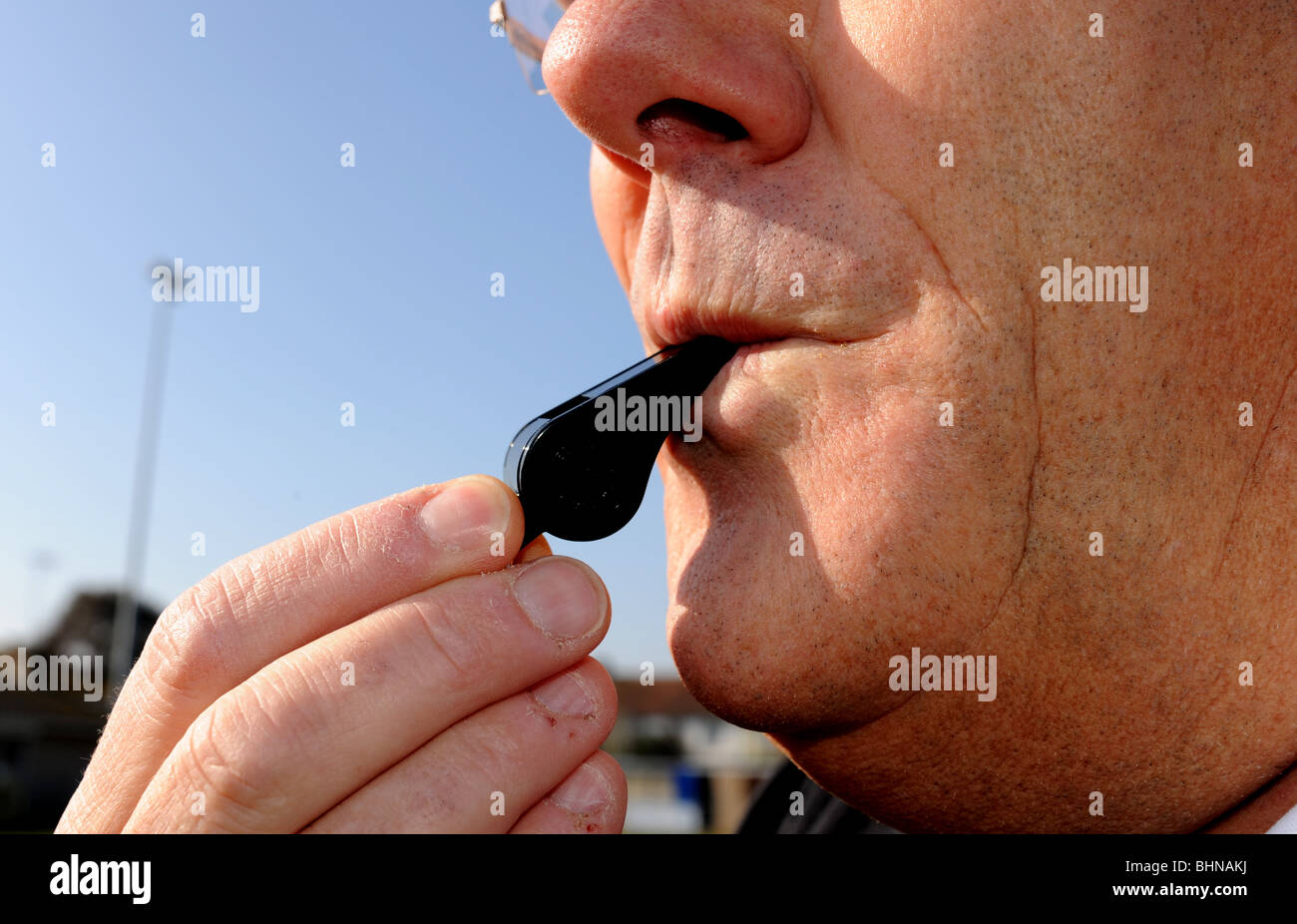 Football referee blowing whistle Stock Photo Alamy