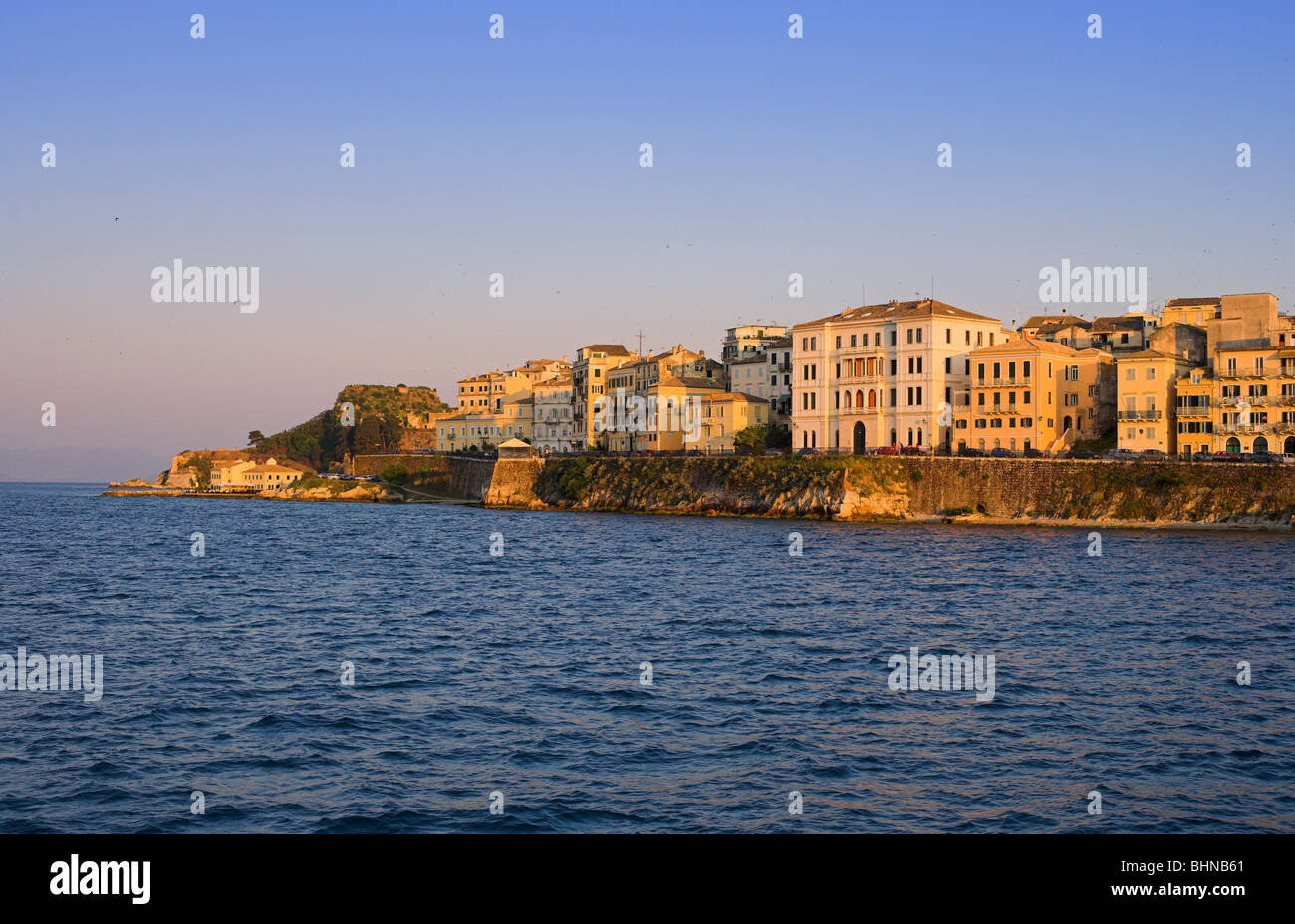 Corfu Town from the sea sunset Venetian style swifts circling above old corfu town Stock Photo