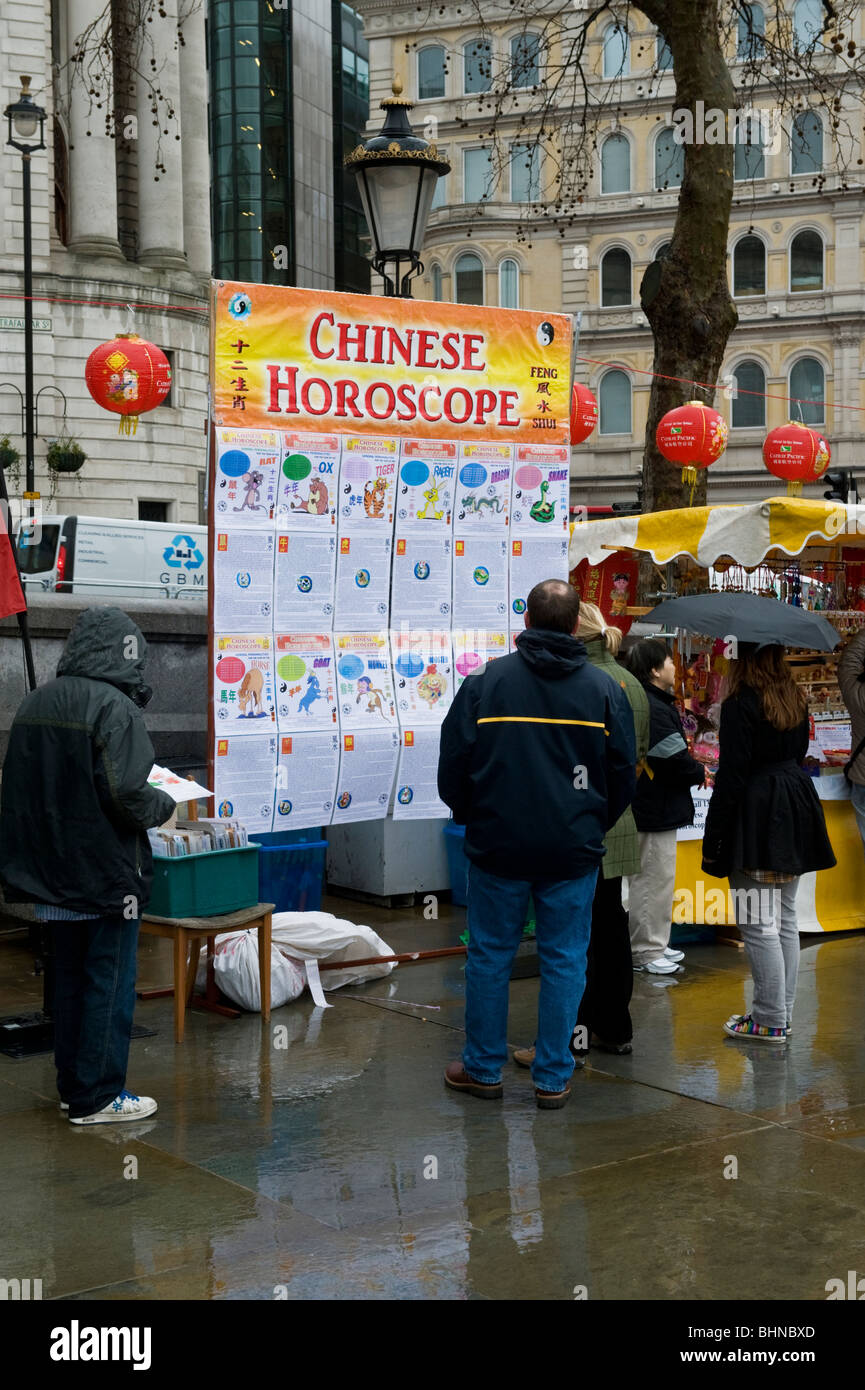 A stall in Trafalgar Square London UK selling lunar new year calendars and horoscopes during a Chinese New Year event Stock Photo