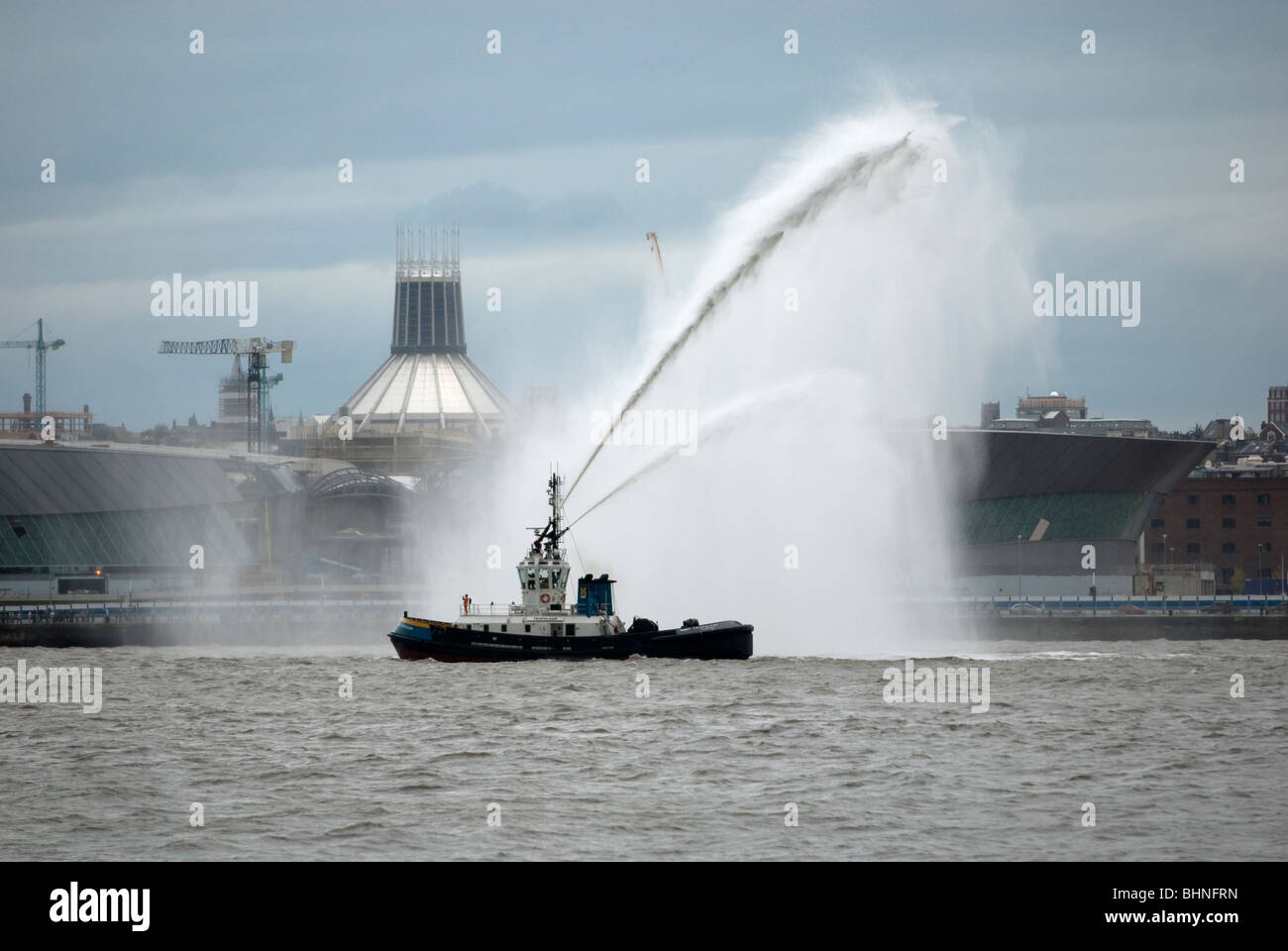 Tug Boat Trafalgar spraying water in Salute on Mersey Stock Photo