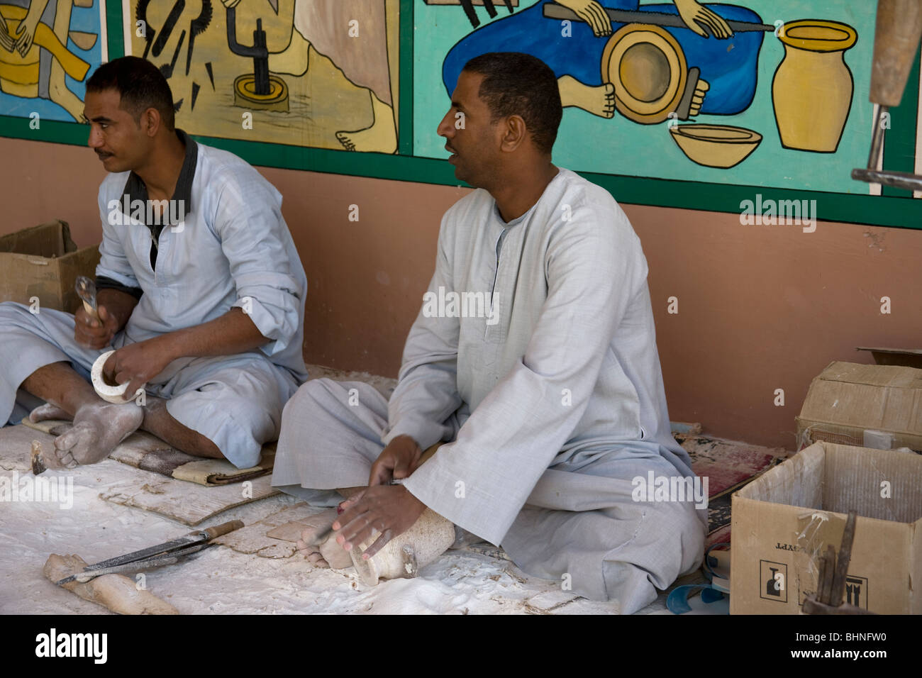 Craftsmen working, refining  alabaster vases outside a shop. Stock Photo