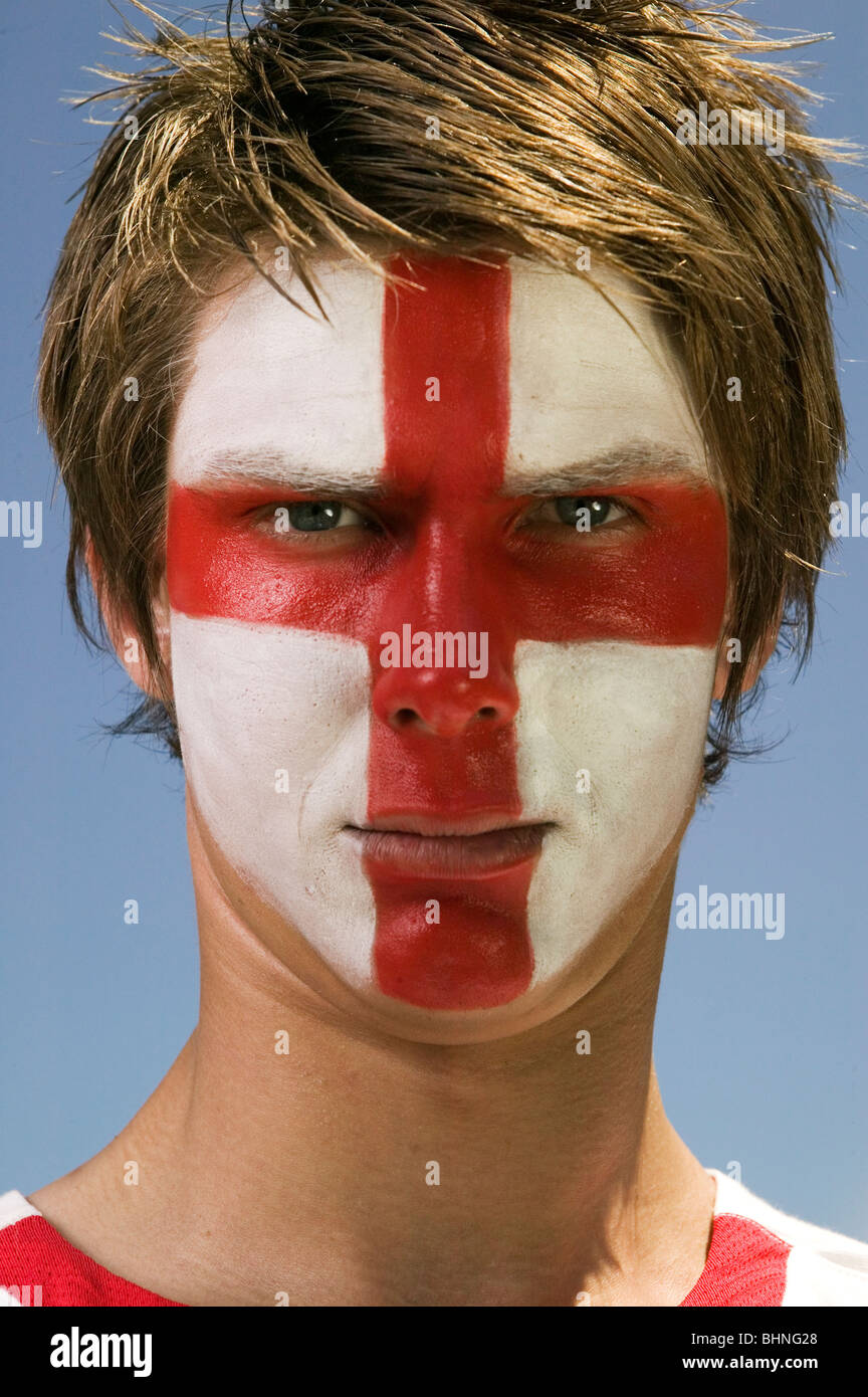 a patriotic England football supporter with the St. George's flag painted on his face Stock Photo
