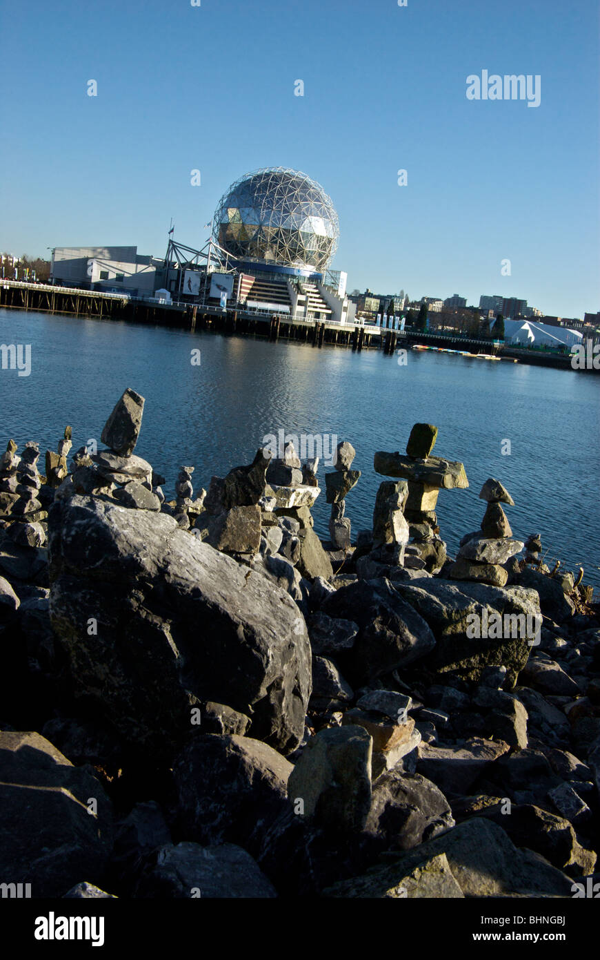 Artistic colony of balanced stone Inuit style Inukshuks logo symbol of 2010 Vancouver Olympics on shore of False Creek Stock Photo
