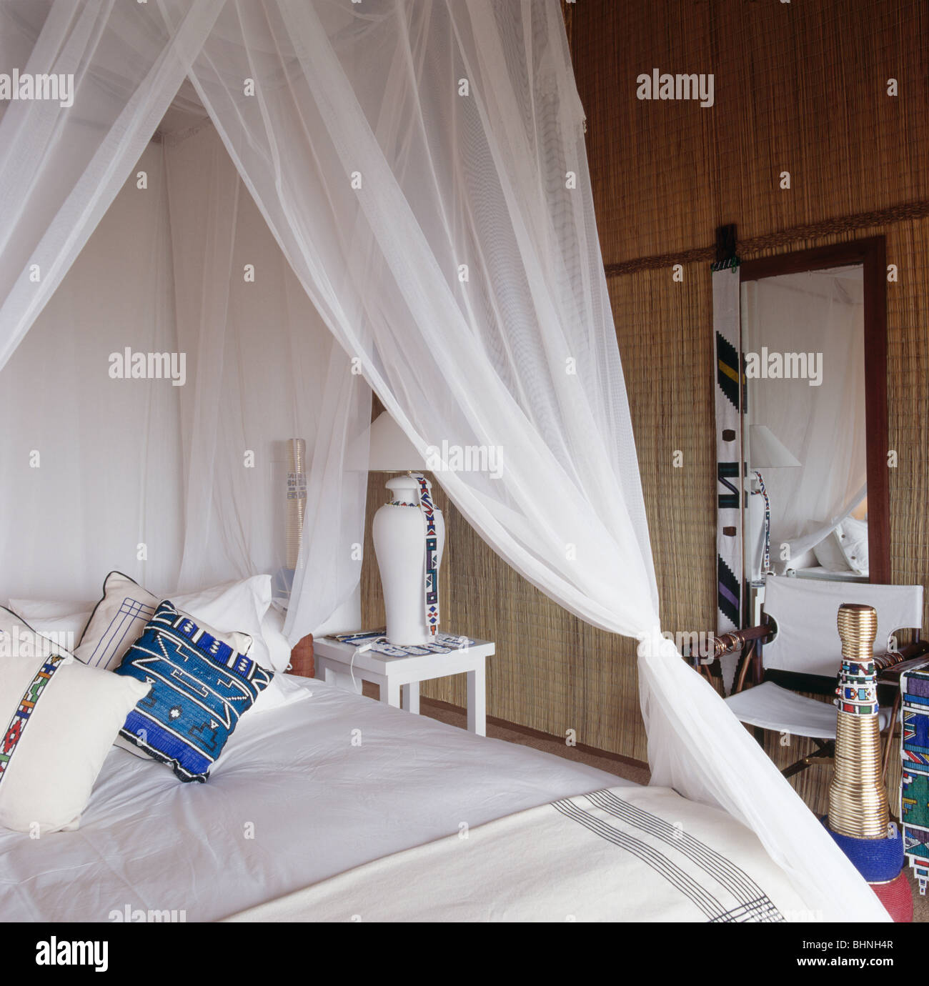 White Voile Drapes On Bed With White And Blue And White