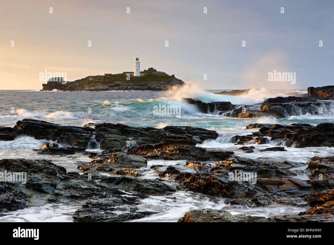 Atlantic waves crashing over the rocks at Godrevy Lighthouse, St Ives Bay Stock Photo