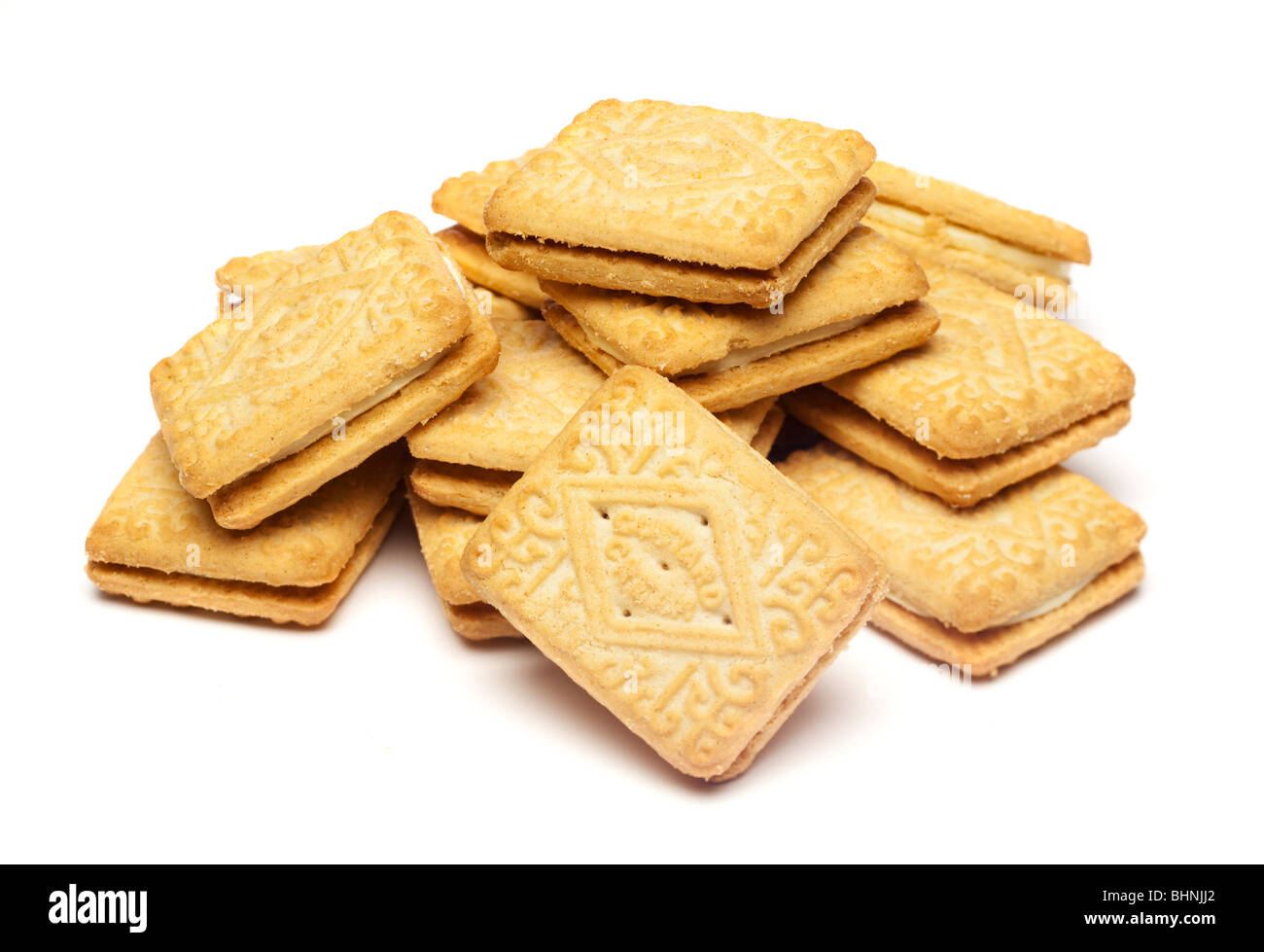 Studio shot of a pile of Custard Cream biscuits cut out isolated on white background Stock Photo