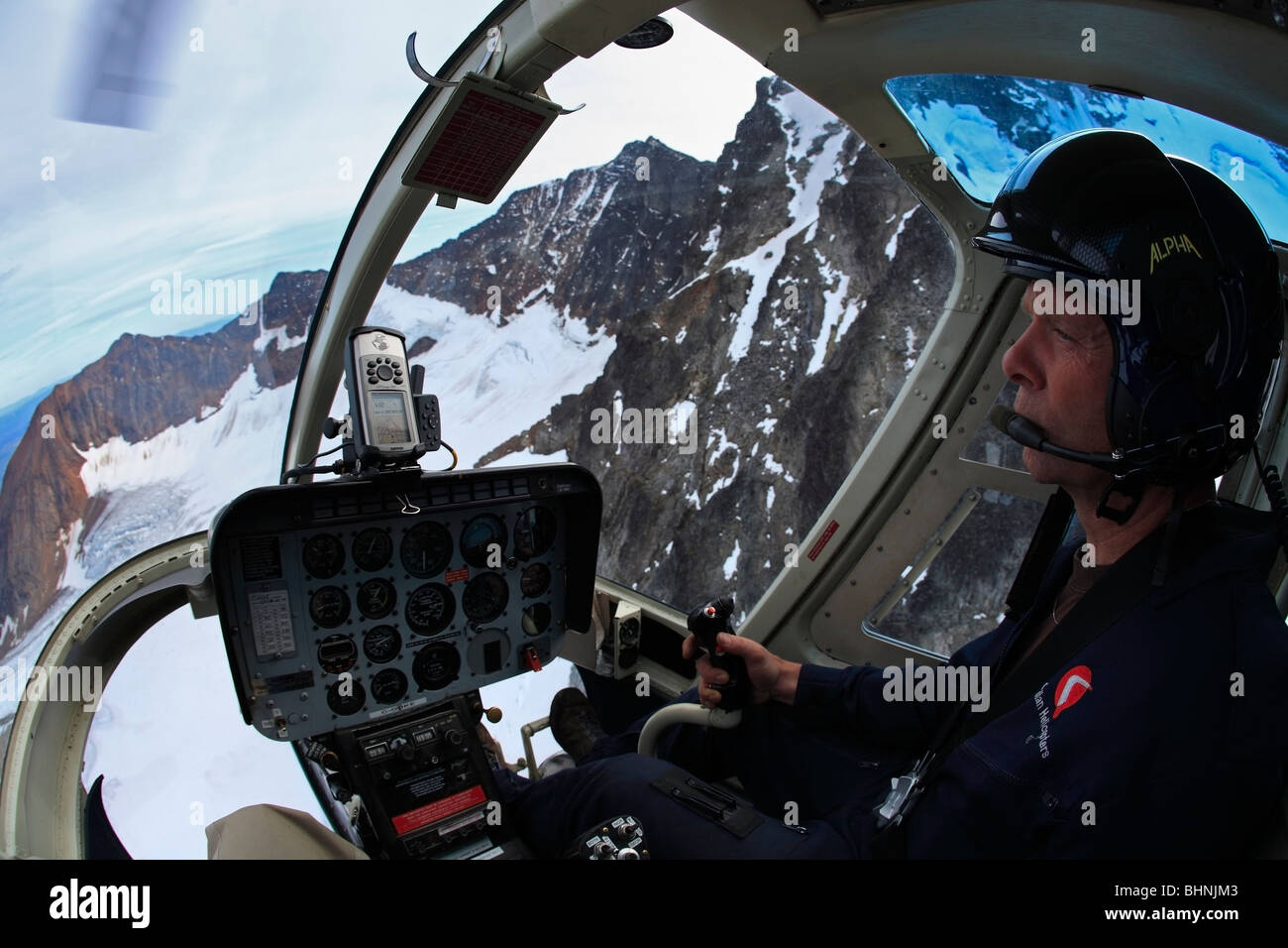 Professional helicopter pilot flying Jet Ranger 206B near Smithers, British Columbia Stock Photo