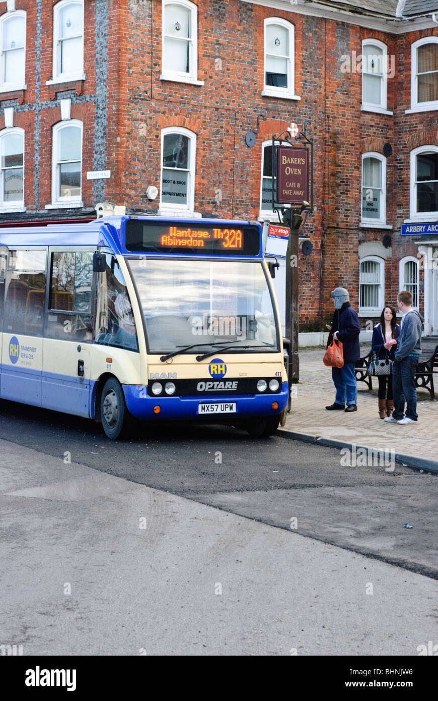 A bus picking up passengers in Wantage Market Place, Oxfordshire, England,United Kingdom. Stock Photo