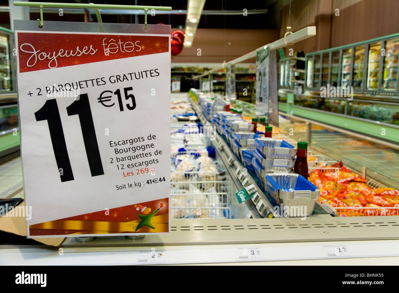 Price / prices point of sale sign, at Christmas, on a row of chest freezers in a French supermarket. France. Stock Photo