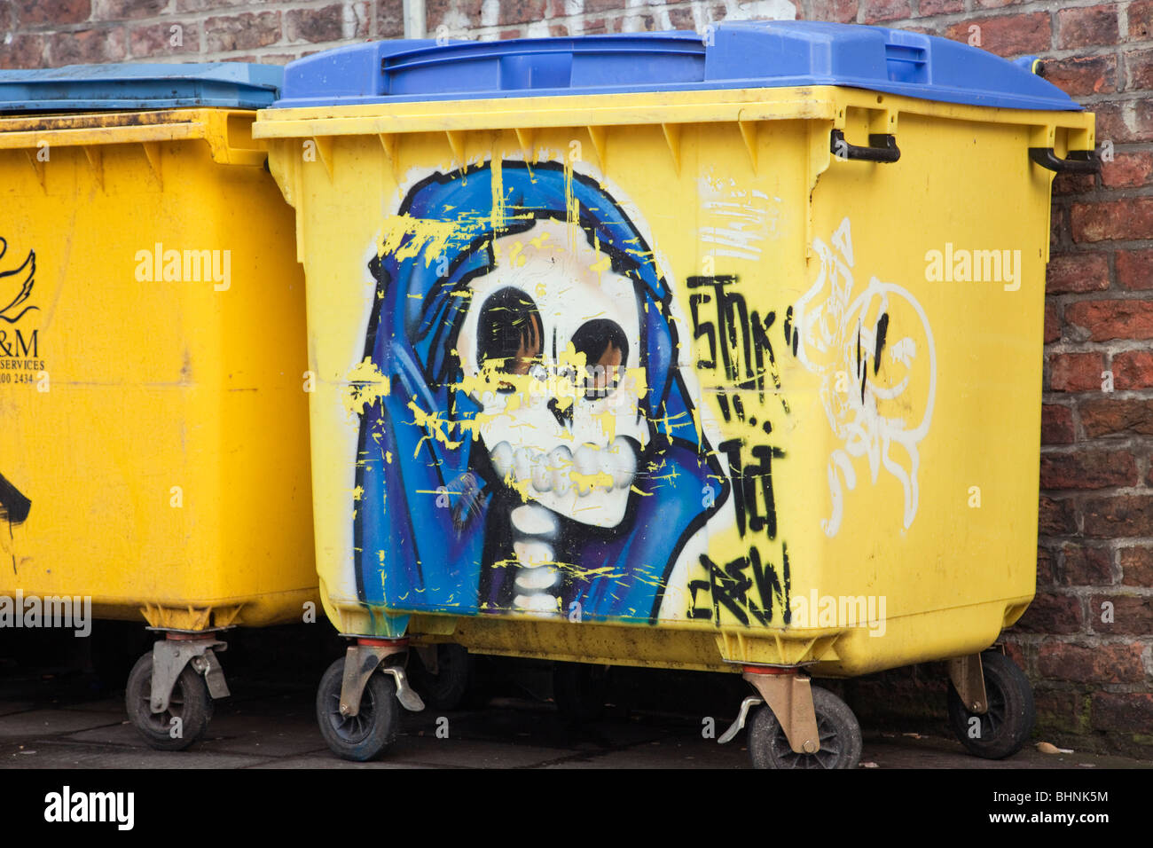 Graffiti on yellow skips in a street. England, UK, Britain Stock Photo