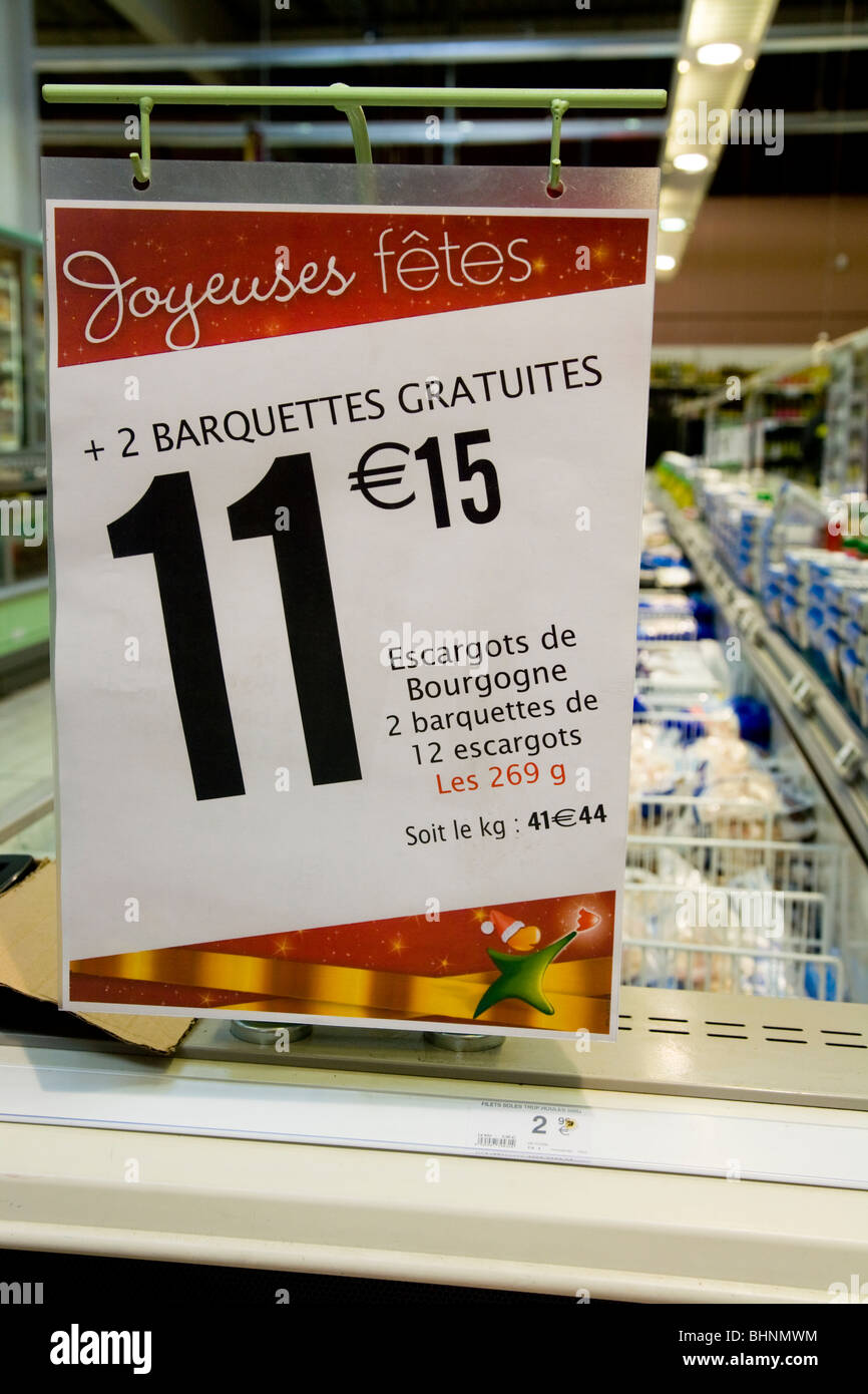 Price / prices point of sale sign, at Christmas, on a row of chest freezers in a French supermarket. France. Stock Photo