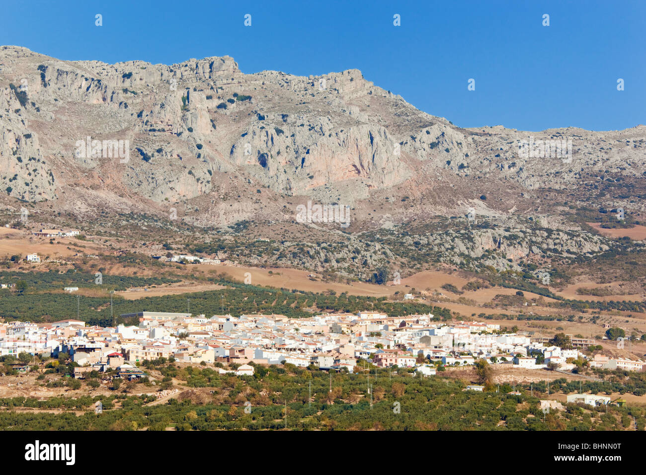 White village of Villanueva de la Concepcion and El Torcal mountains in background, Spain. Stock Photo