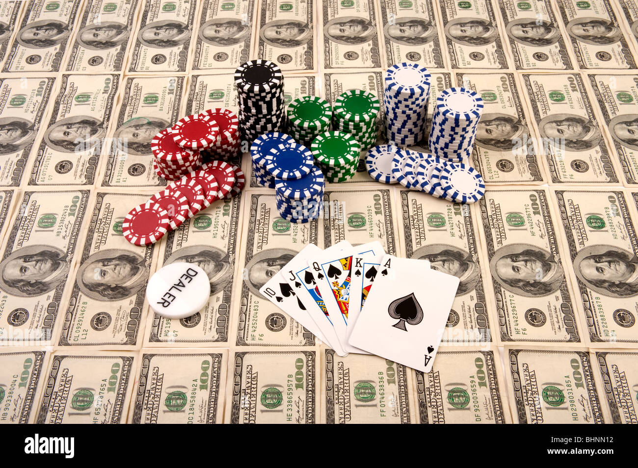 Winning poker hand in a pile of 100 dollar bills with chips Stock