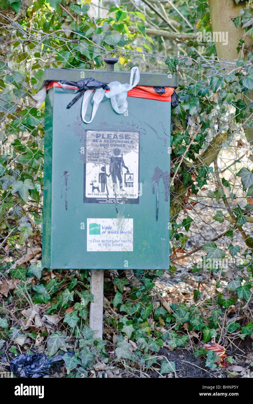 Overflowing Dog Litter Bin with Vale of White Horse Council markings on. Stock Photo