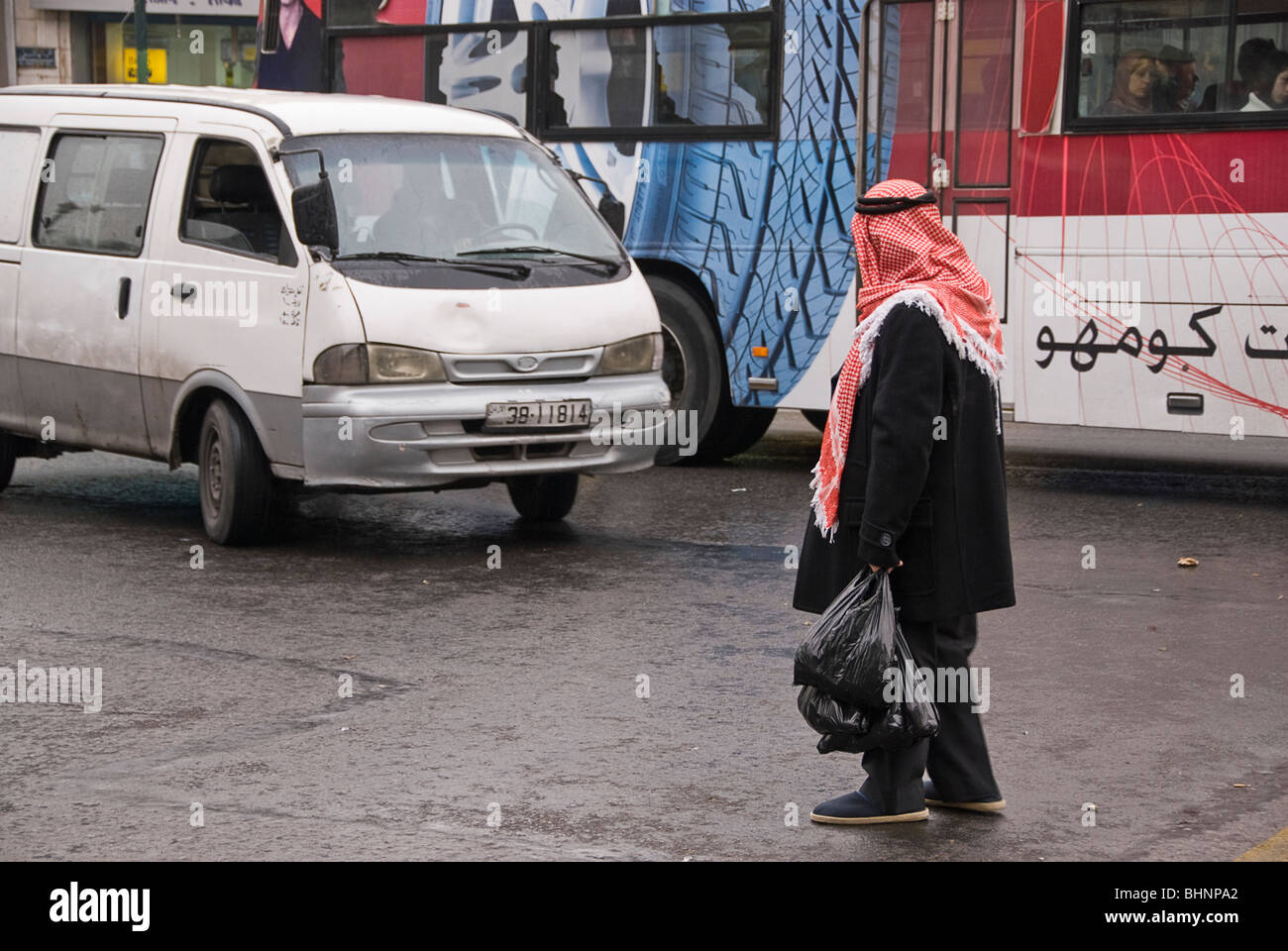 Old arab man with Kaffiyah waiting for the trafic to crossthe street. Amman,  Jordan, Asia Stock Photo - Alamy