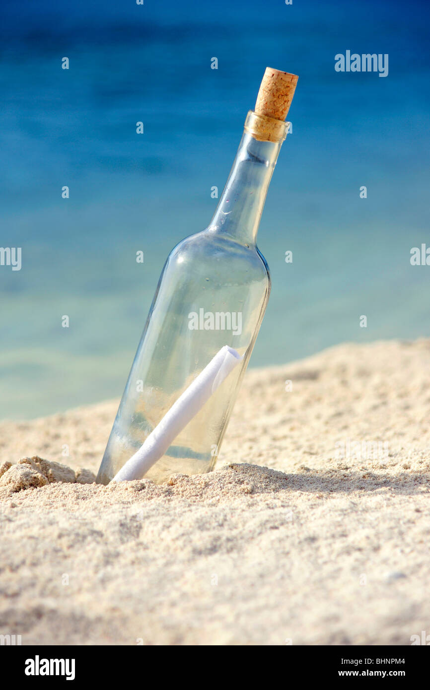 Message in a bottle on an isolated beach Stock Photo