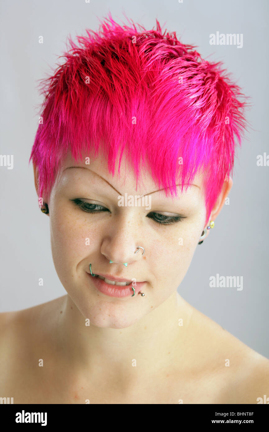 Pretty girl with very brightly dyed red pink hair. Stock Photo