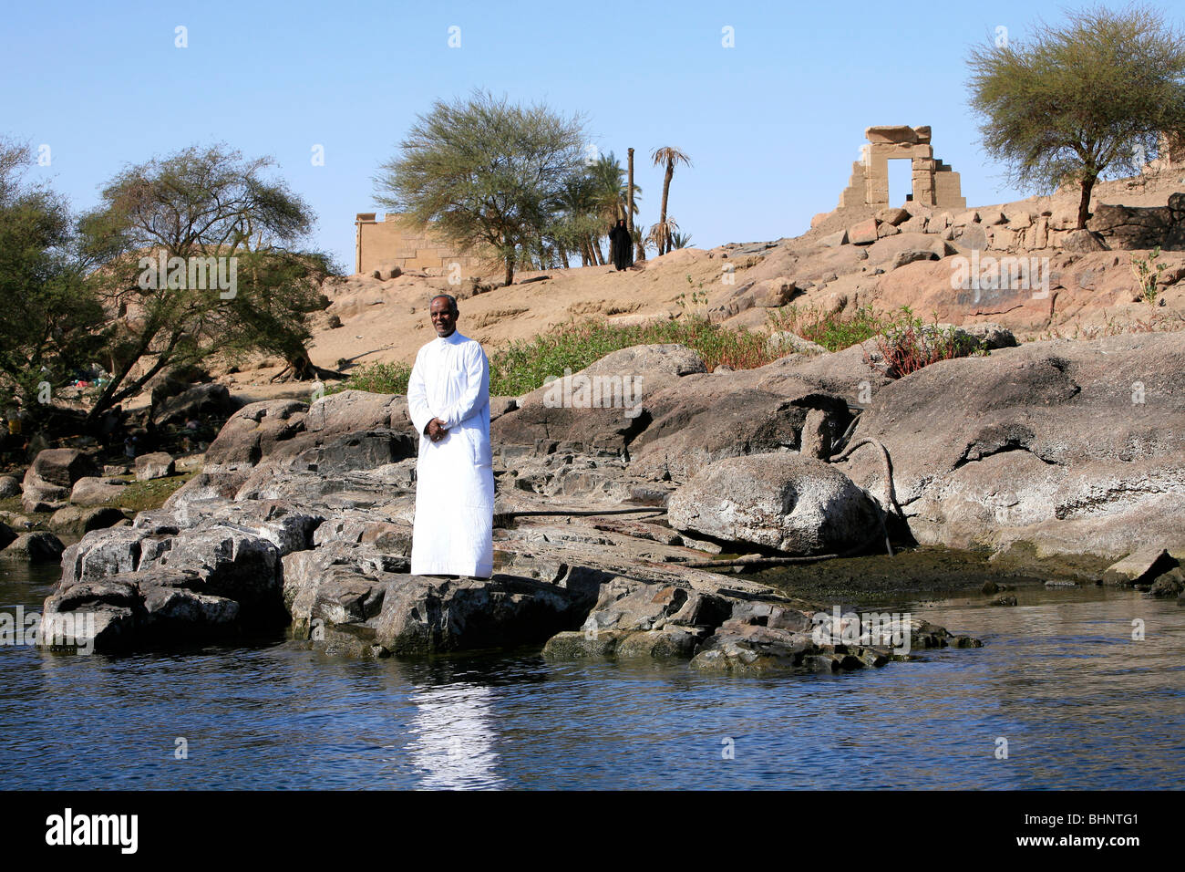 Nubian man and woman standing in front of the Temple of Khnum on Elephantine Island in Aswan, Egypt Stock Photo