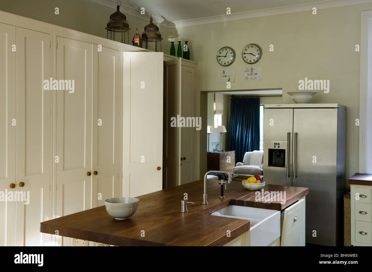 Iroko wooden worktop with Belfast sink in Kitchen with white storage