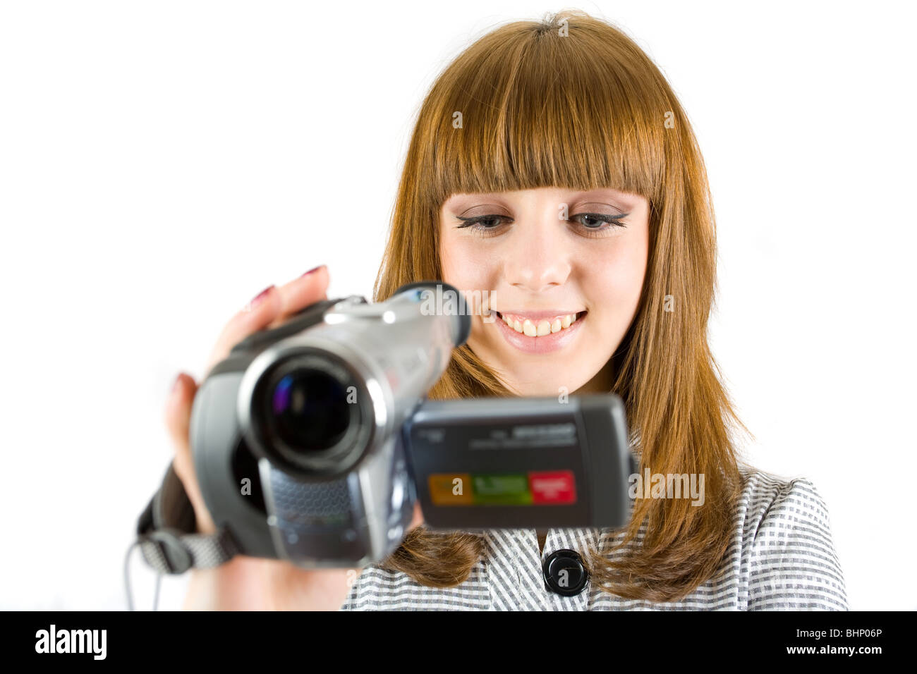 Girl using video camera (camcorder), isolated on white background Stock