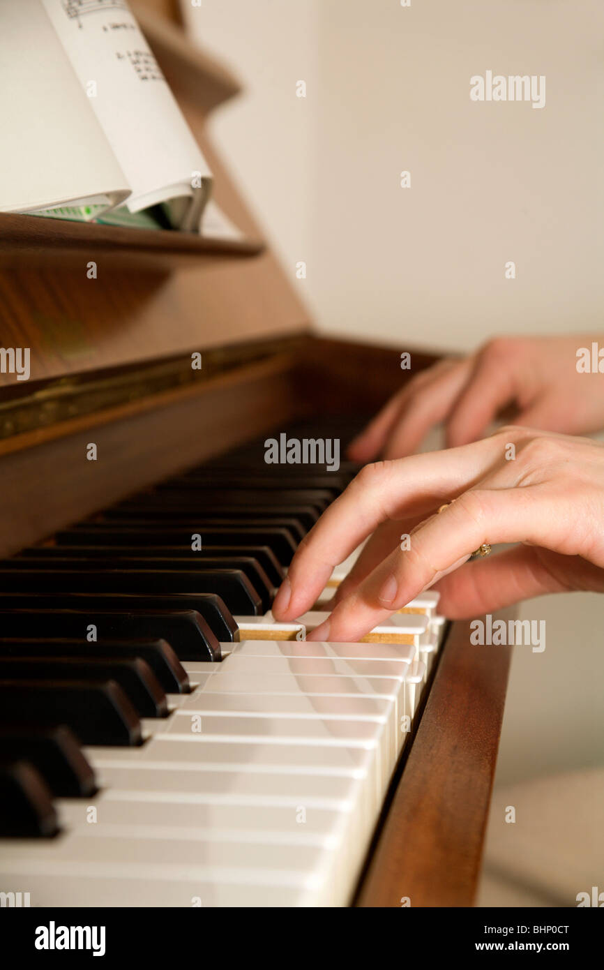 hands of woman by piano playing Stock Photo