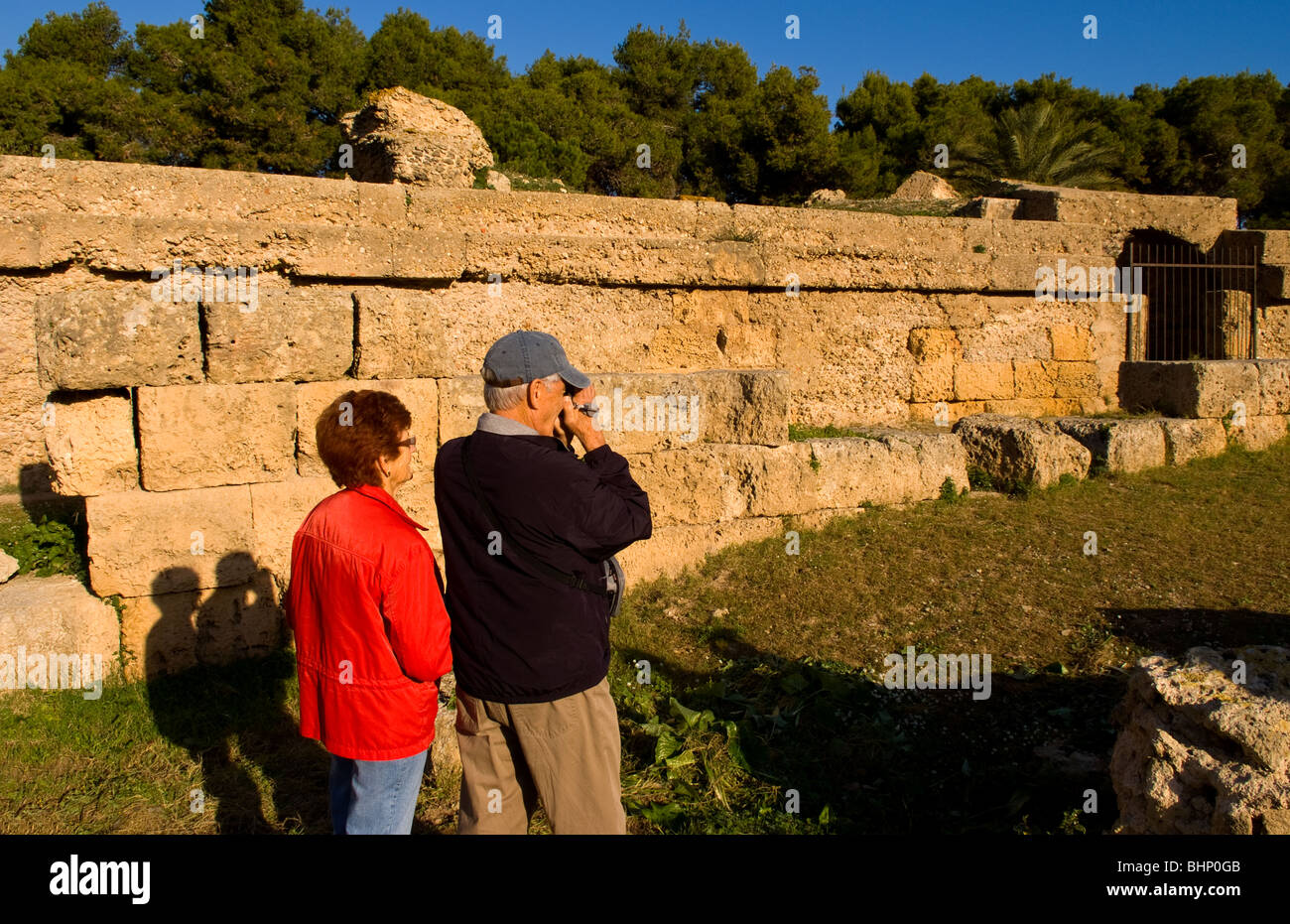 Tourist taking pictures at Carthage Tunisia Roman Amphitheater old ruins in Northern Africa Stock Photo