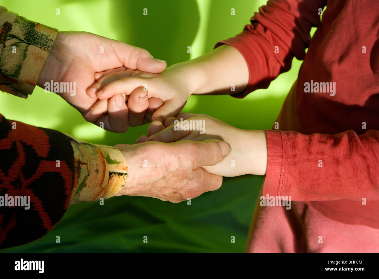 hands of old woman and the child Stock Photo