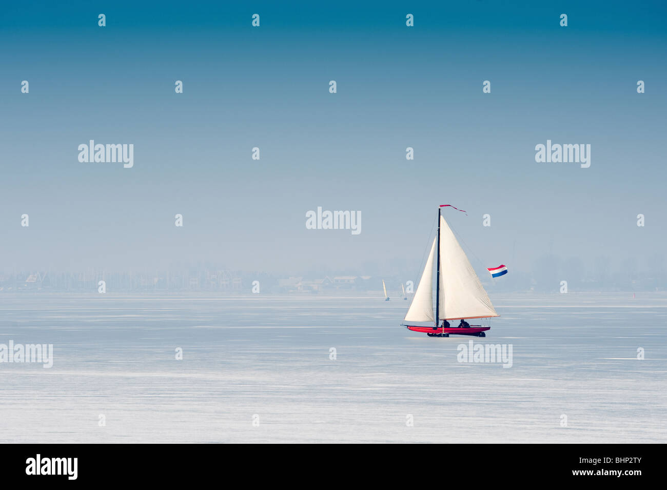 Ice sailing on the frozen lake (gouwzee Between Edam and Marken Netherlands) Stock Photo