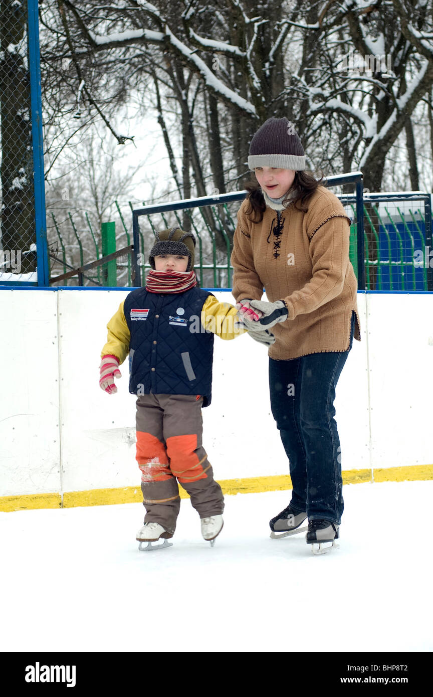 winter - Mum learn to skate a Boy Stock Photo